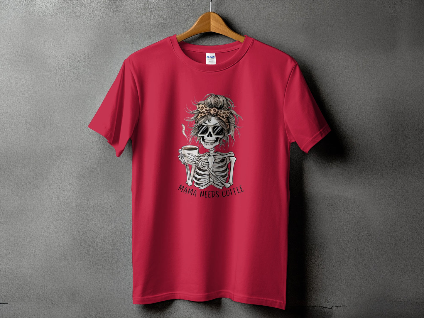 Red t-shirt with skeleton graphic holding coffee and text "MAMA NEEDS COFFEE."