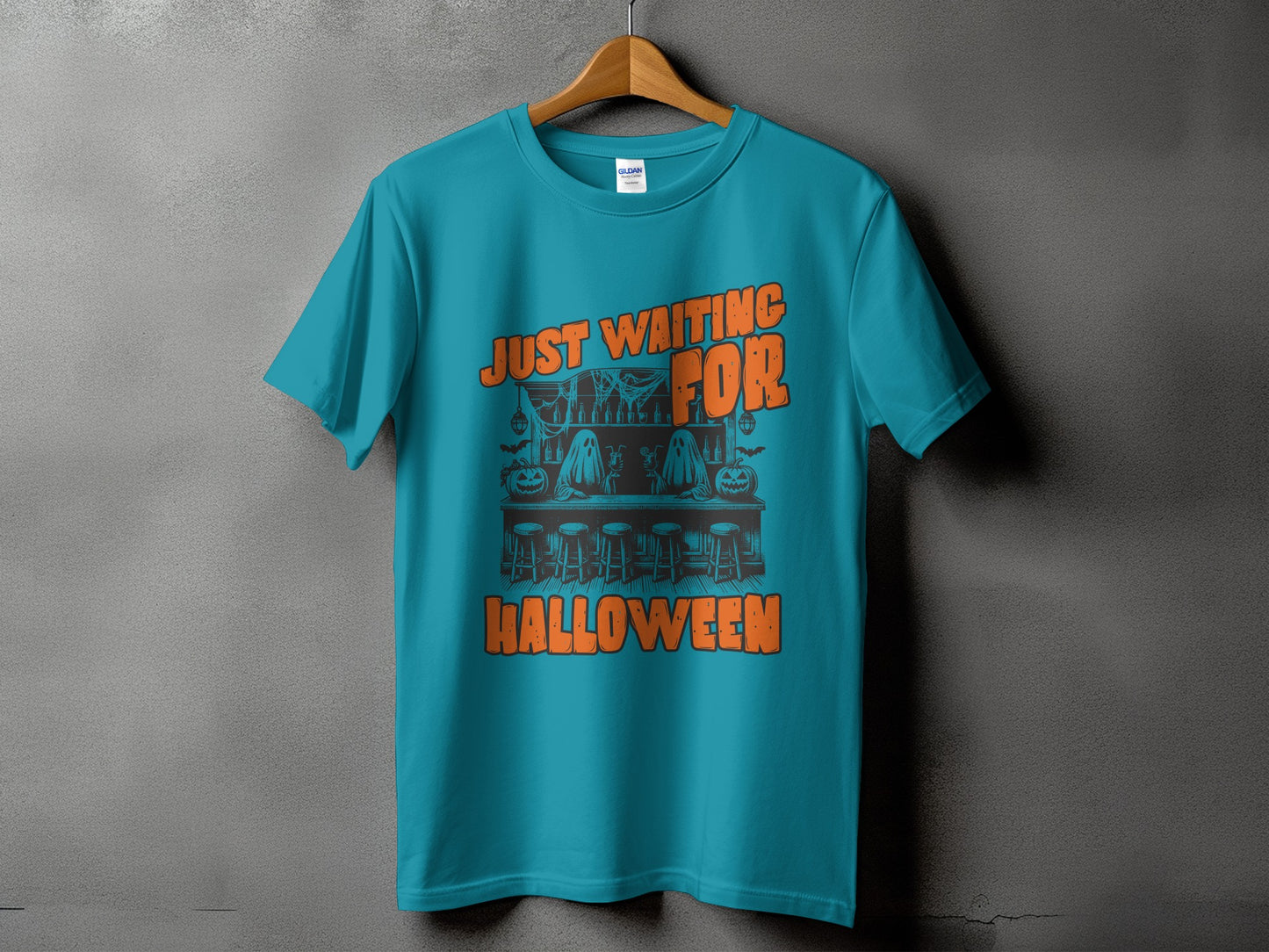 Teal t-shirt with "Just Waiting For Halloween" text and Halloween bar scene graphic.