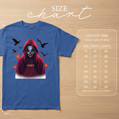 Blue t-shirt with graphic of clown in red hoodie surrounded by crows and pumpkins.