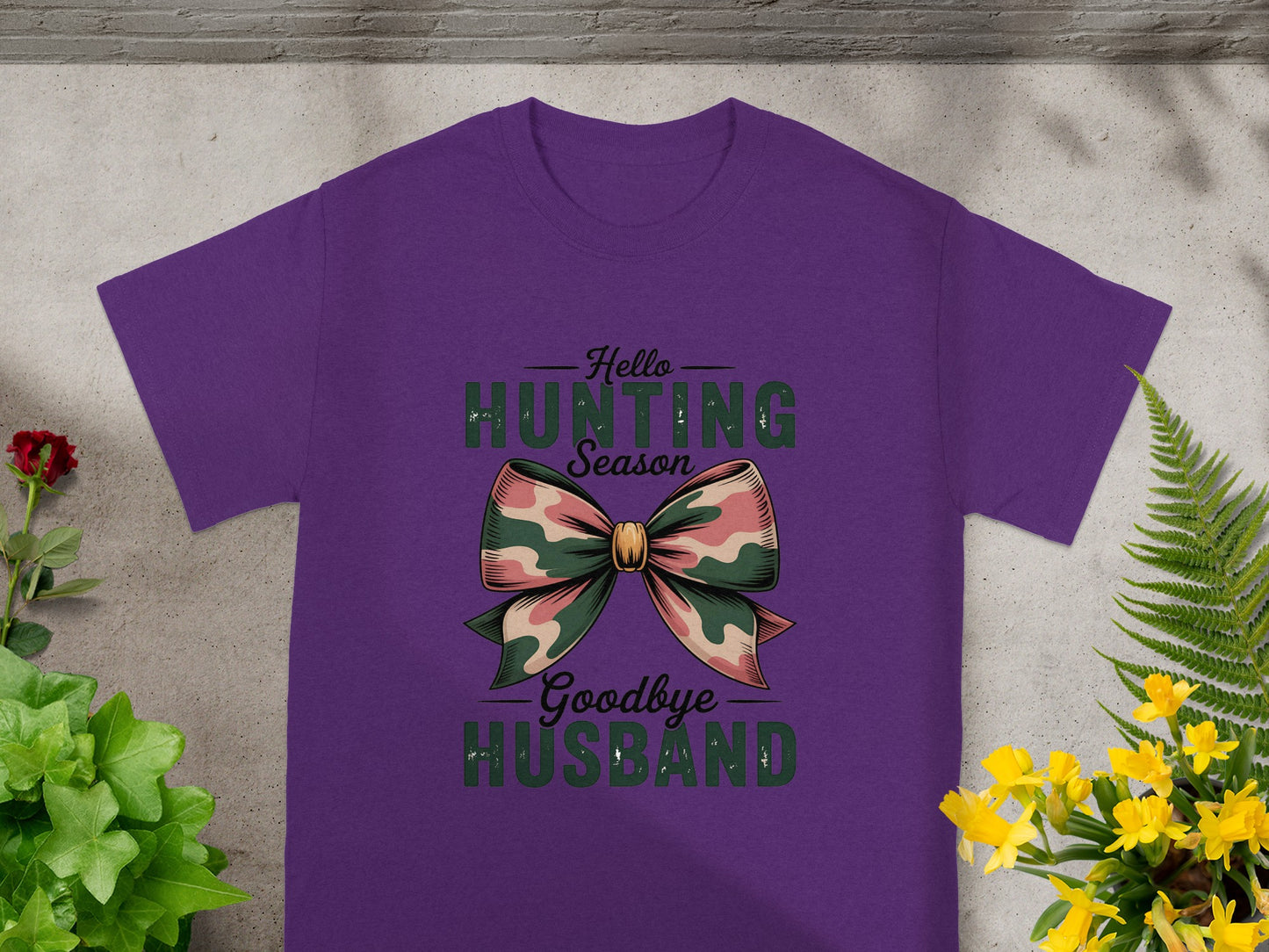 Purple t-shirt with "Hello Hunting Season Goodbye Husband" text and camouflage bow graphic.