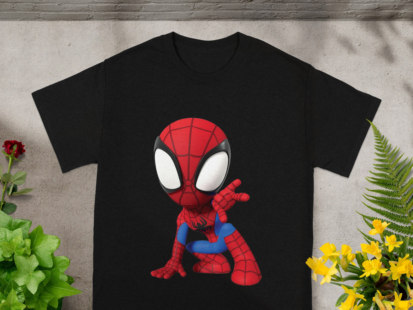 Black t-shirt featuring a cartoon Spider-Man graphic in a crouching pose.
