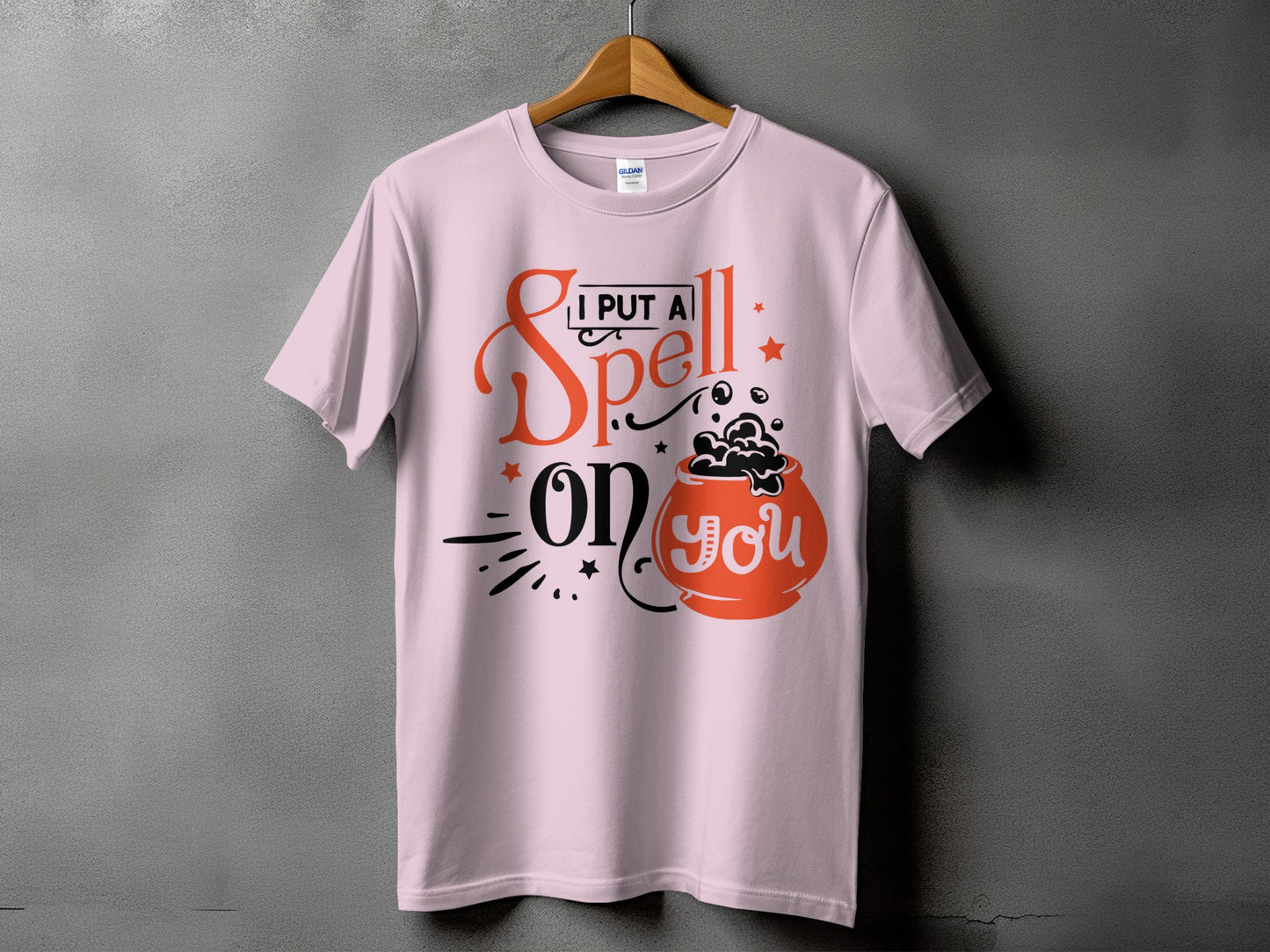 Pink t-shirt with "I put a spell on you" and cauldron graphic.