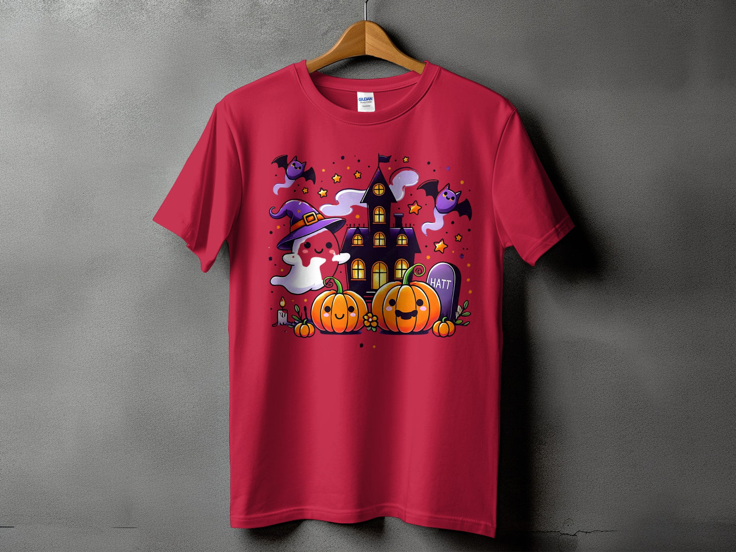 Red t-shirt with Halloween theme featuring pumpkins, ghost, bats, haunted house, and tombstone.