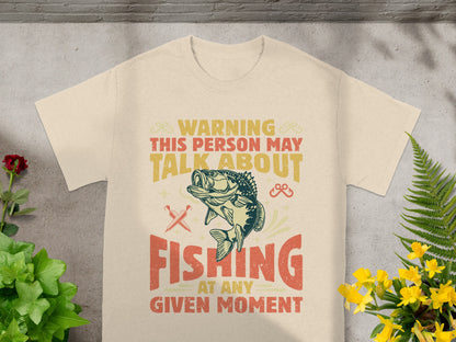 Cream t-shirt with "Warning: This person may talk about fishing at any given moment" text.