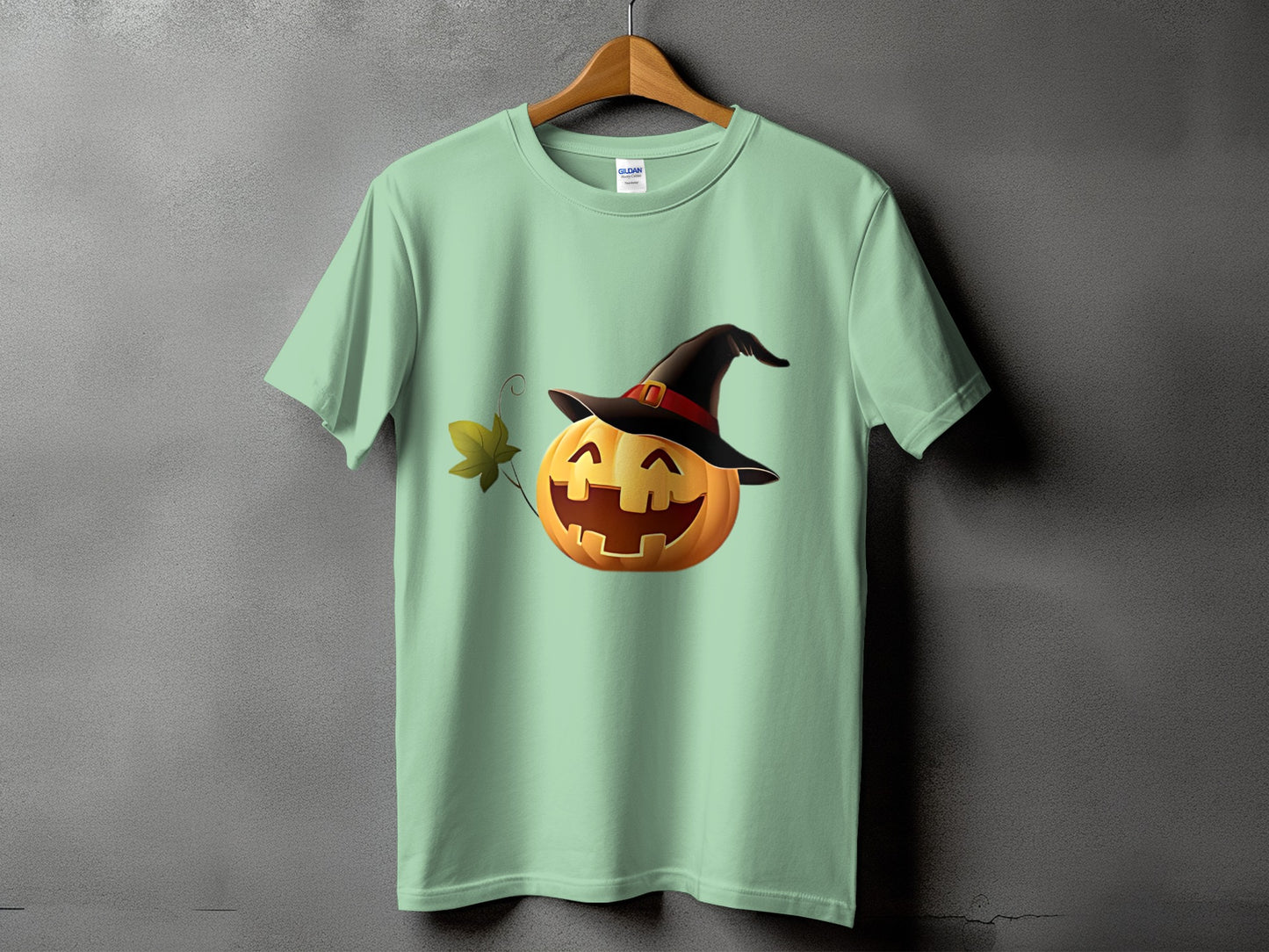 Green t-shirt with a smiling jack-o'-lantern wearing a witch hat.
