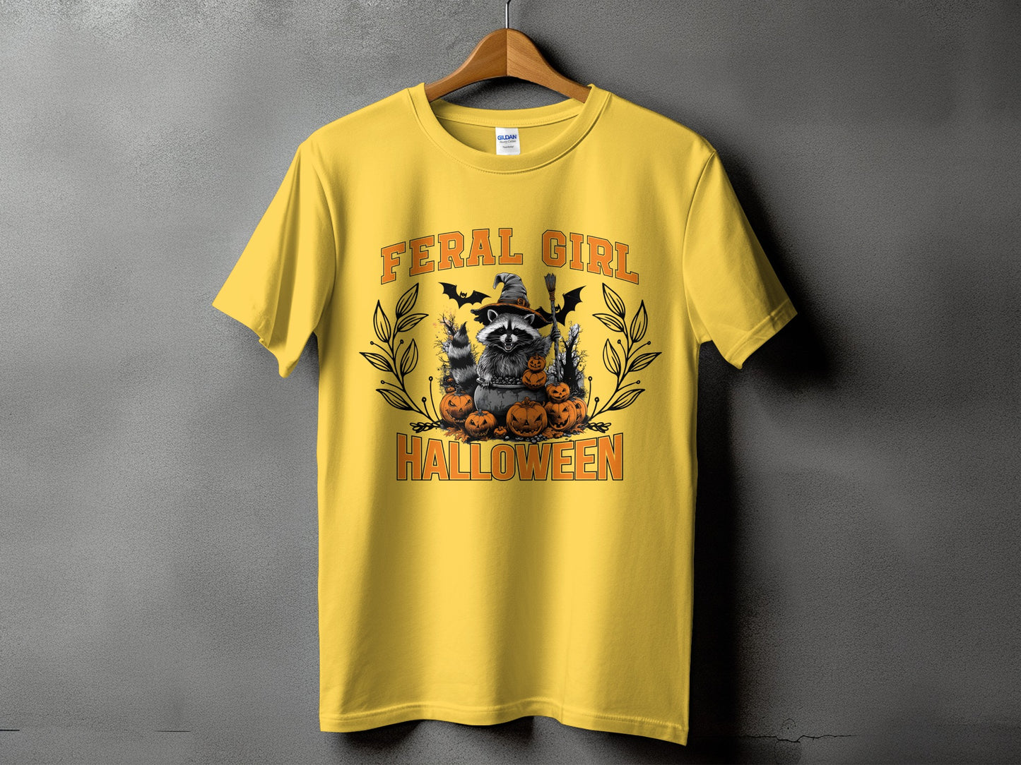 Yellow t-shirt with "FERAL GIRL HALLOWEEN" text and raccoon Halloween graphic.