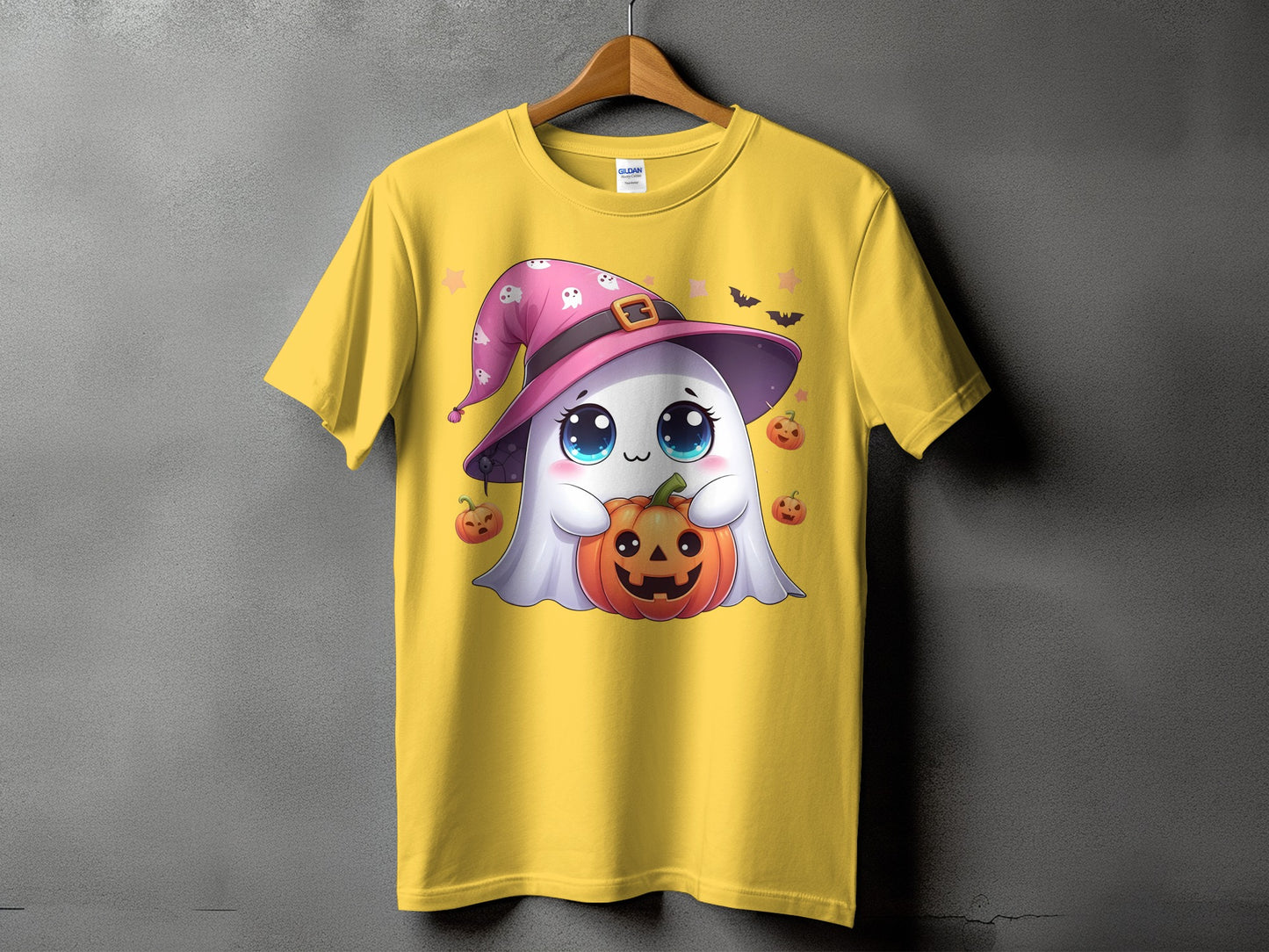 Yellow t-shirt with a cartoon ghost holding a jack-o'-lantern and wearing a witch hat.