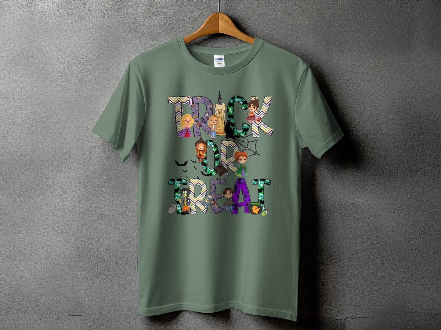 Green t-shirt with "Trick or Treat" Halloween graphic featuring cartoon characters and bats.