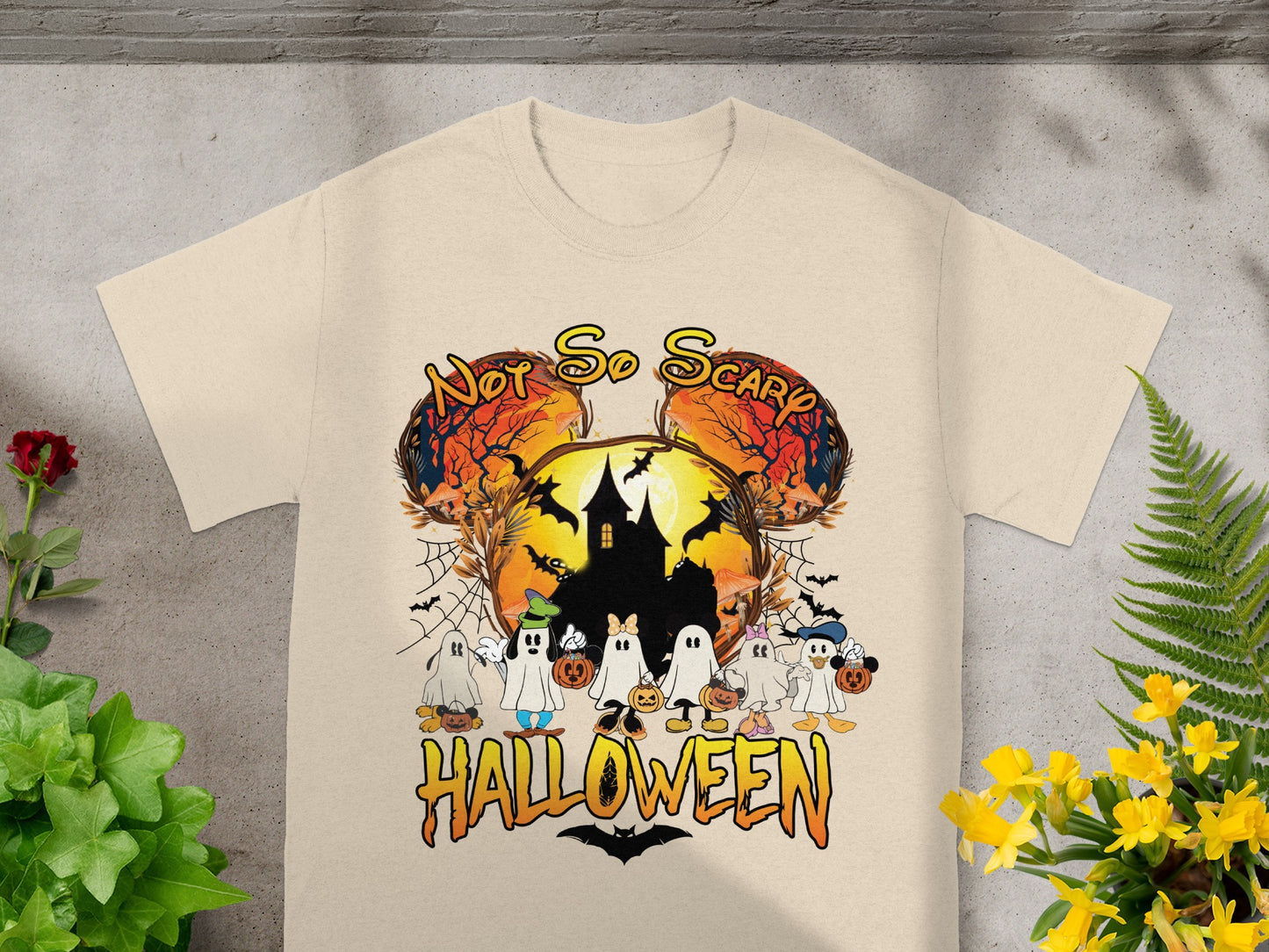 Light beige t-shirt with "Not So Scary Halloween" and cartoon ghosts, castle, and Mickey ears.