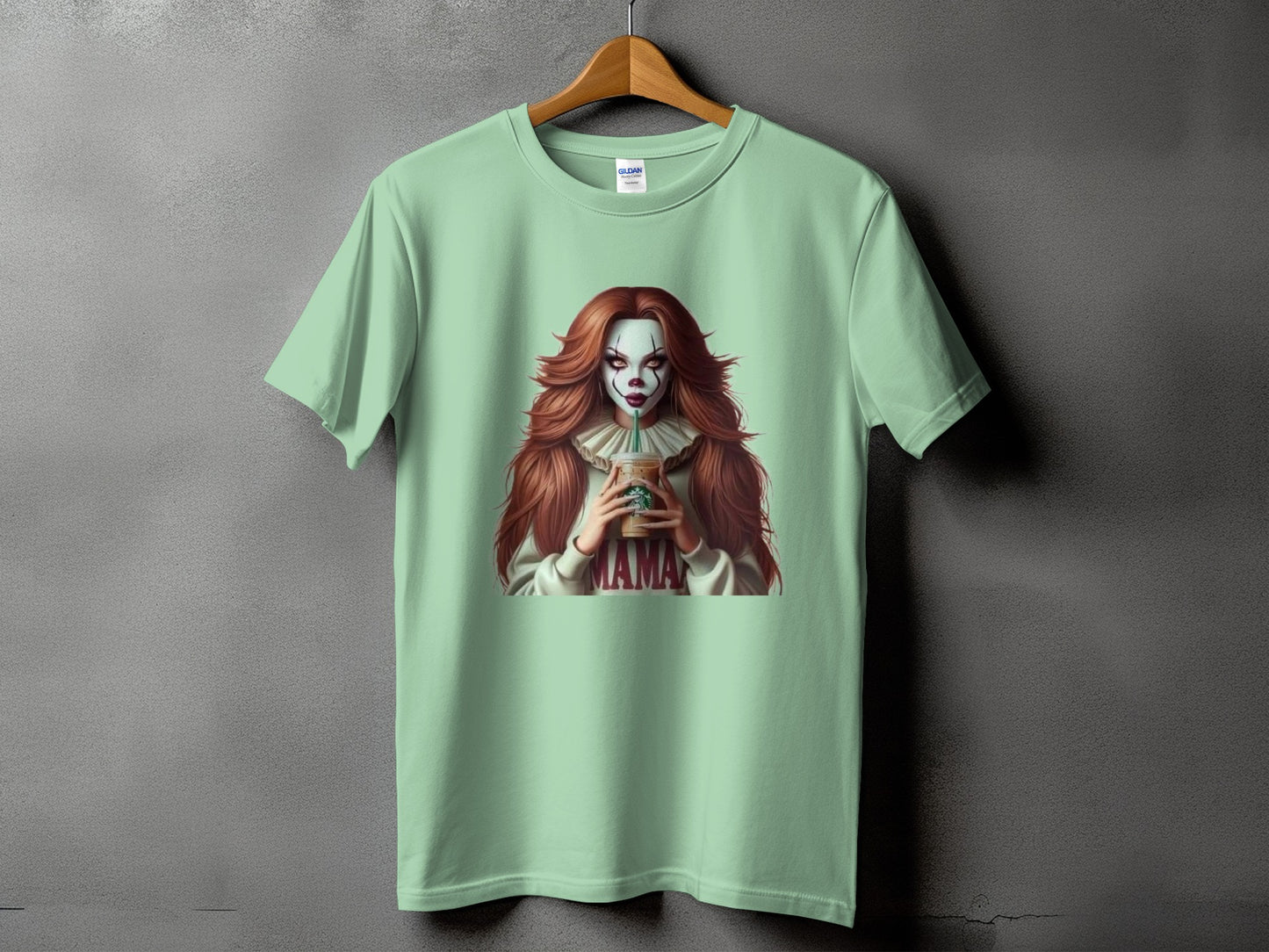 Light green t-shirt with a clown graphic holding a Starbucks cup and the word "MAMA."