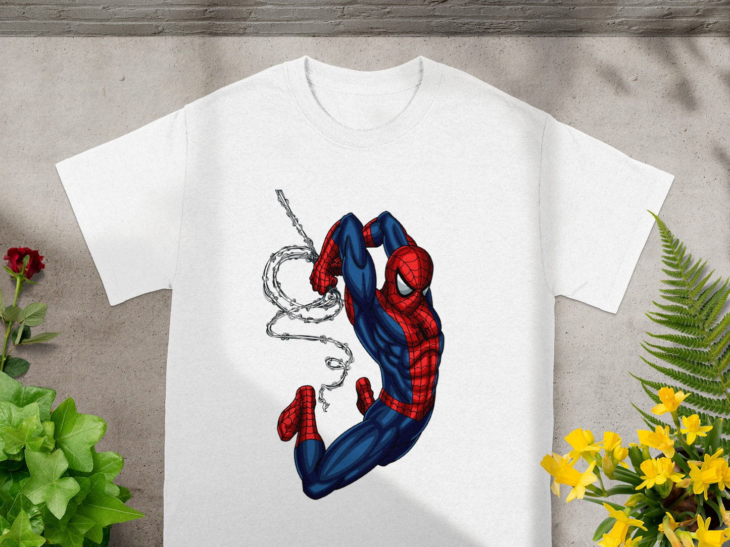 White t-shirt with Spiderman swinging from a web.