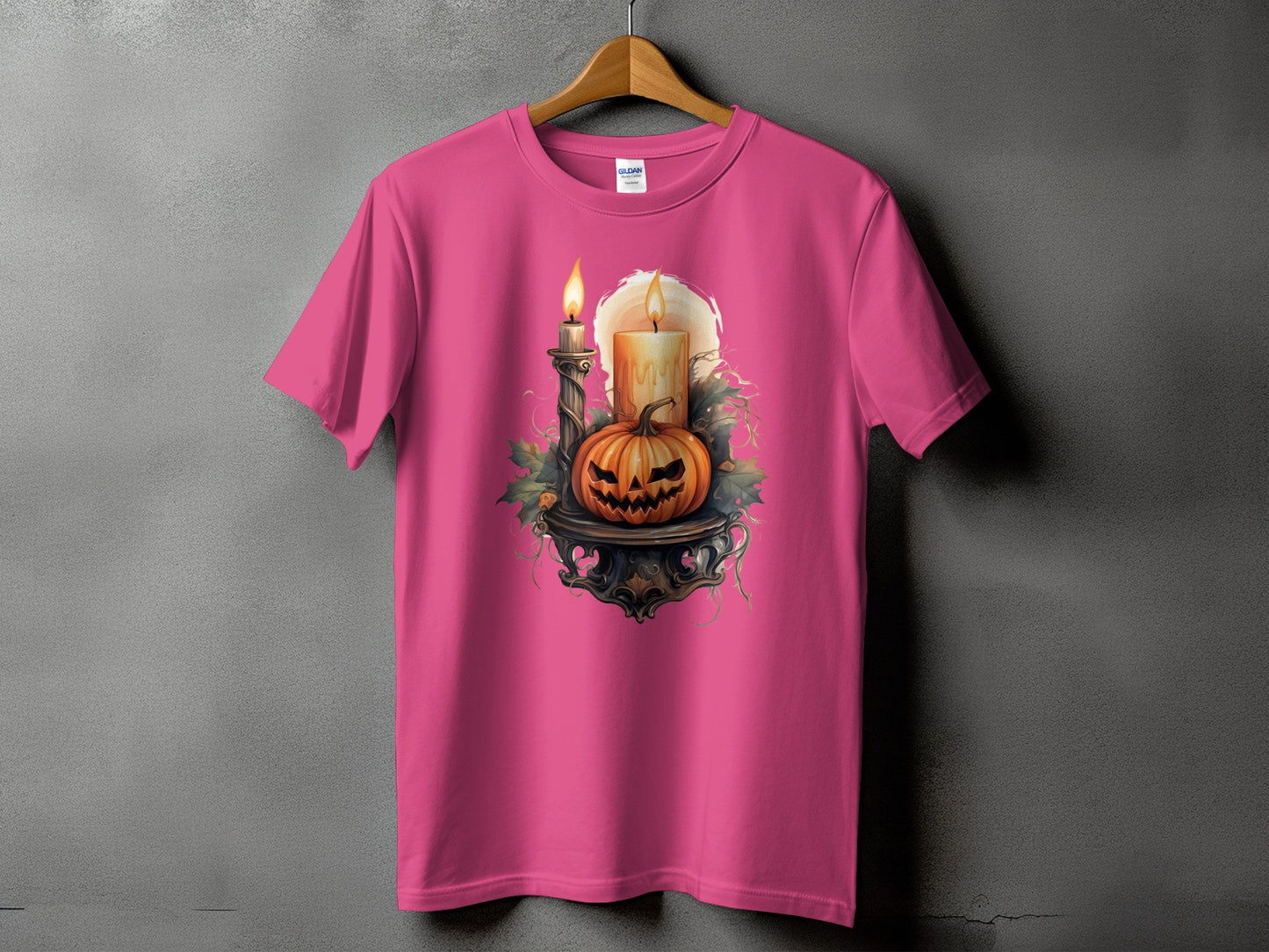 Pink t-shirt with a Halloween design featuring a jack-o'-lantern and candles.