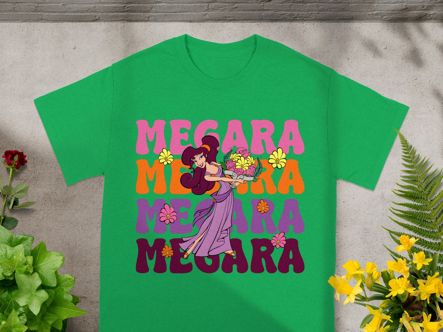 Green t-shirt with "Megara" in colorful, retro font and a woman holding flowers.