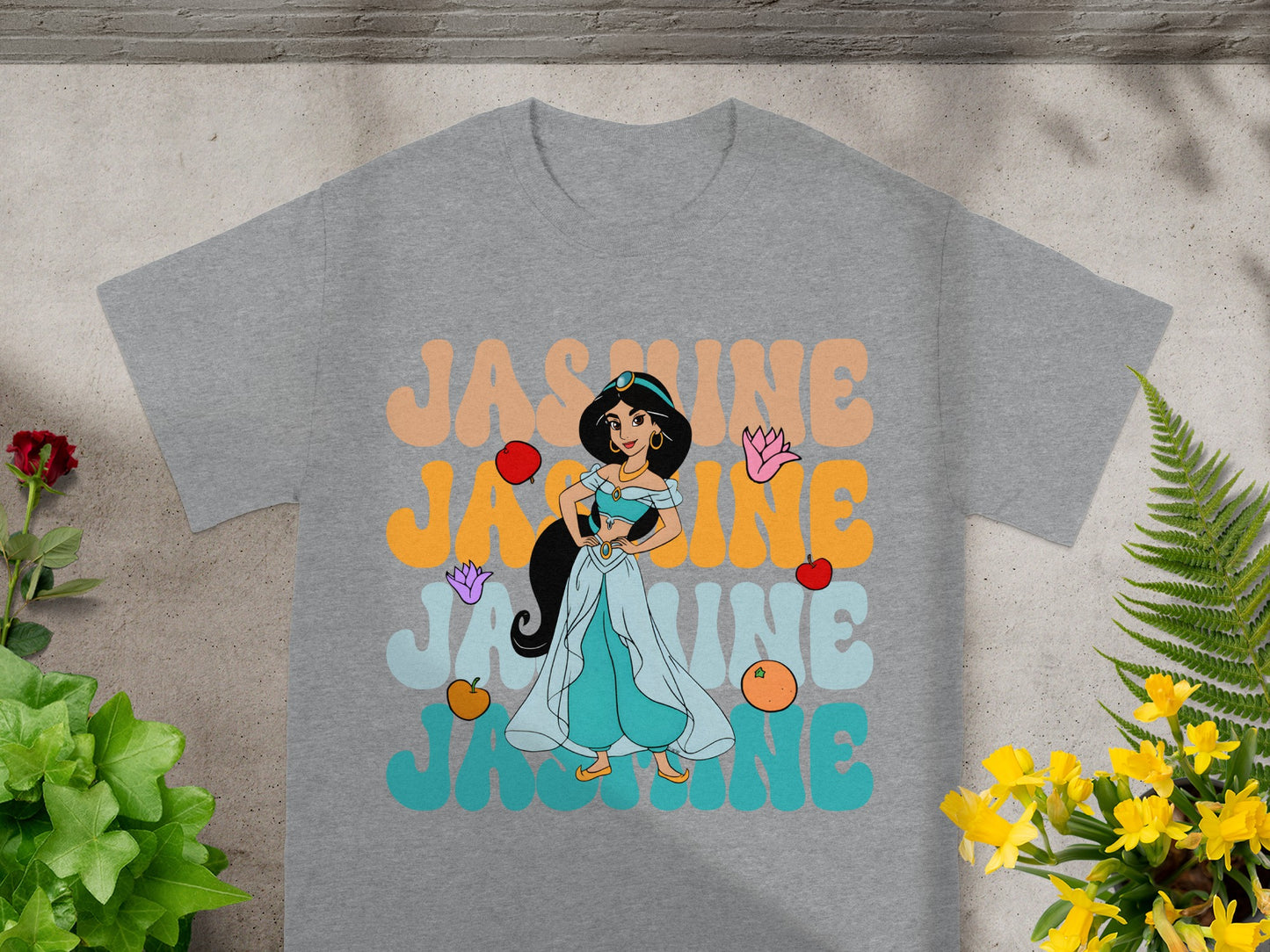 Grey t-shirt with Jasmine cartoon and "JASMINE" text in colorful retro lettering.