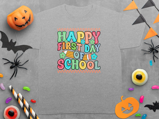 Gray t-shirt with "Happy First Day Of School" text and Halloween-themed decorations.