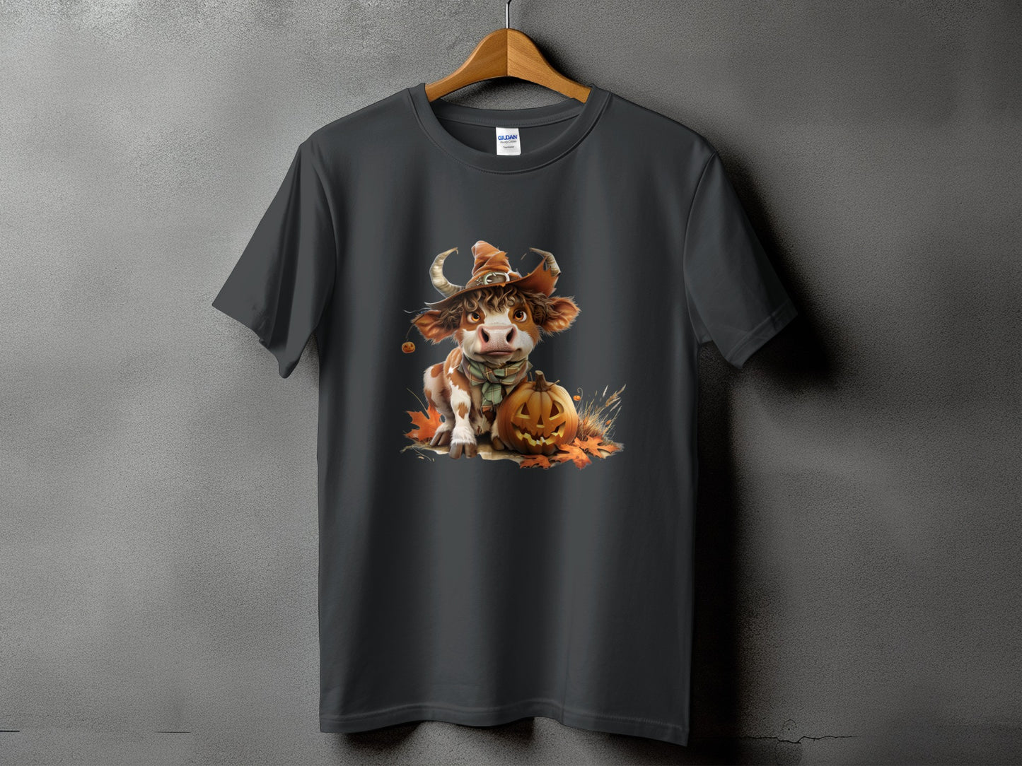 Dark grey t-shirt featuring a Halloween cow wearing a witch hat and scarf with a pumpkin.