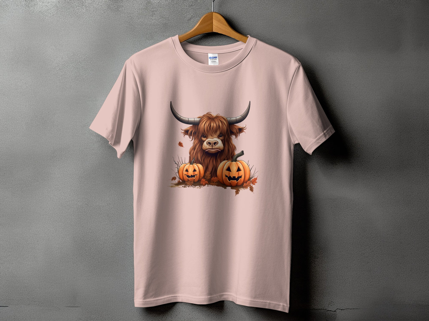 Pink t-shirt with a Highland cow and two jack-o'-lanterns design.