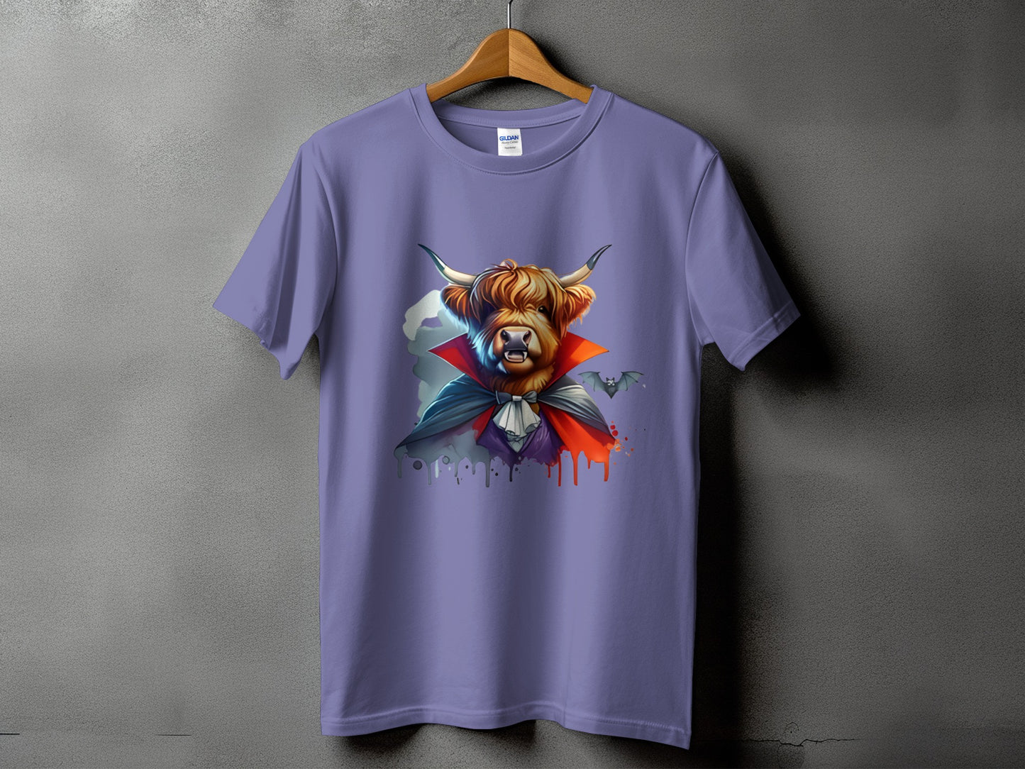 Highland cow dressed as a vampire with bats on a purple t-shirt.