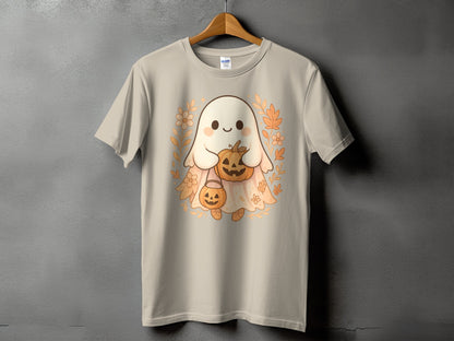 Cute ghost holding pumpkins surrounded by leaves and flowers on a tan t-shirt.