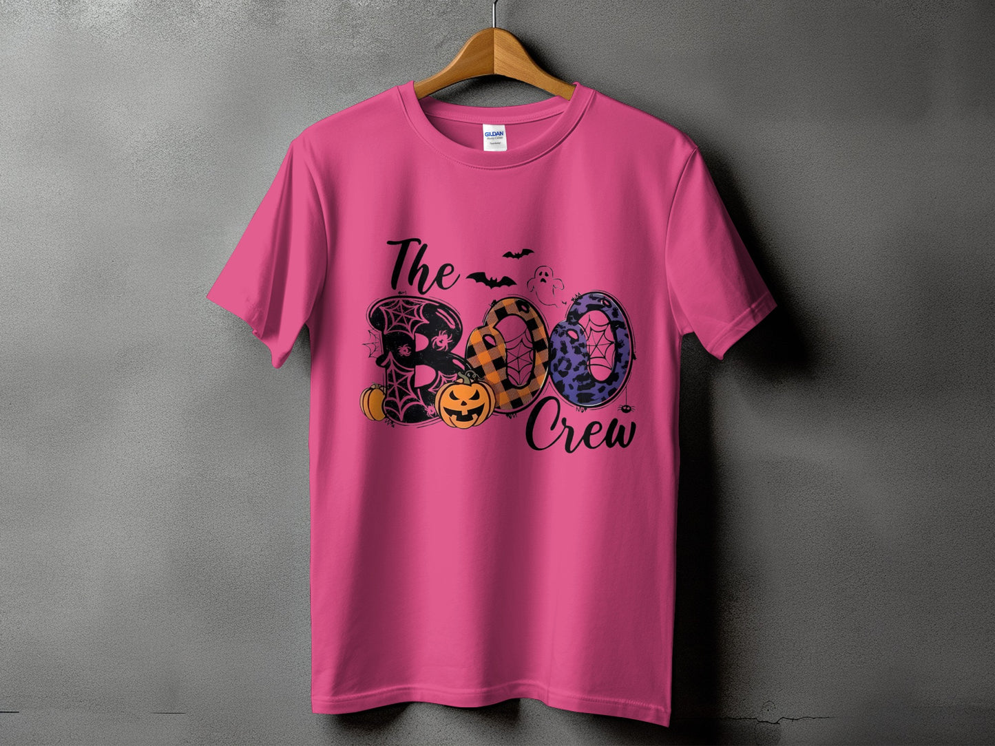 Pink t-shirt with "The Boo Crew" text and Halloween graphics.
