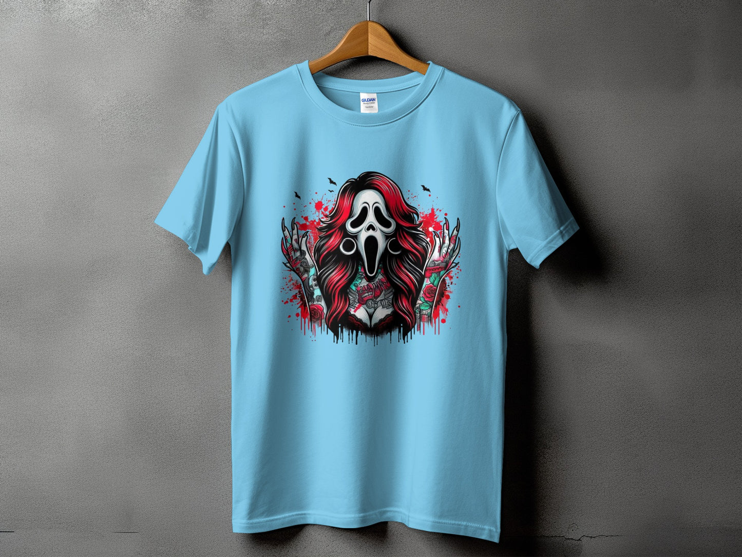 Light blue t-shirt with graphic of screaming ghost mask, roses, and tattoos.