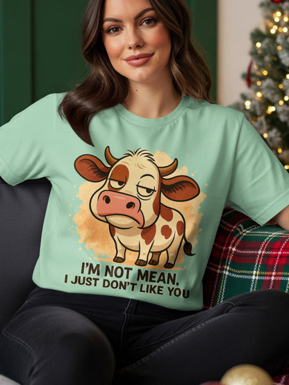 Mint t-shirt with a cartoon cow and text "I'm not mean, I just don't like you".