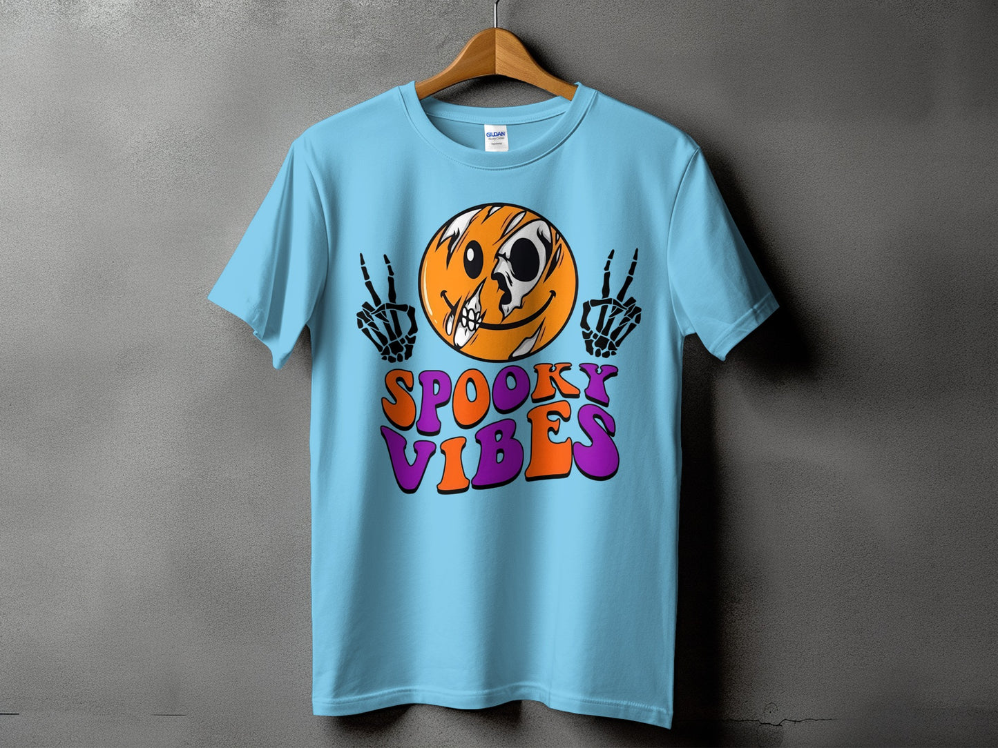 Light blue t-shirt with skeleton hands, skull smiley, and "Spooky Vibes" text.