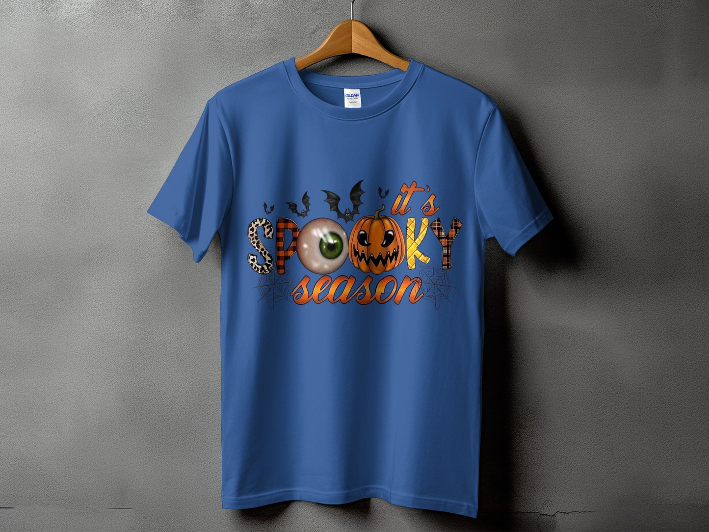 Blue t-shirt with "it's SPOOKY season" Halloween graphic and bats.
