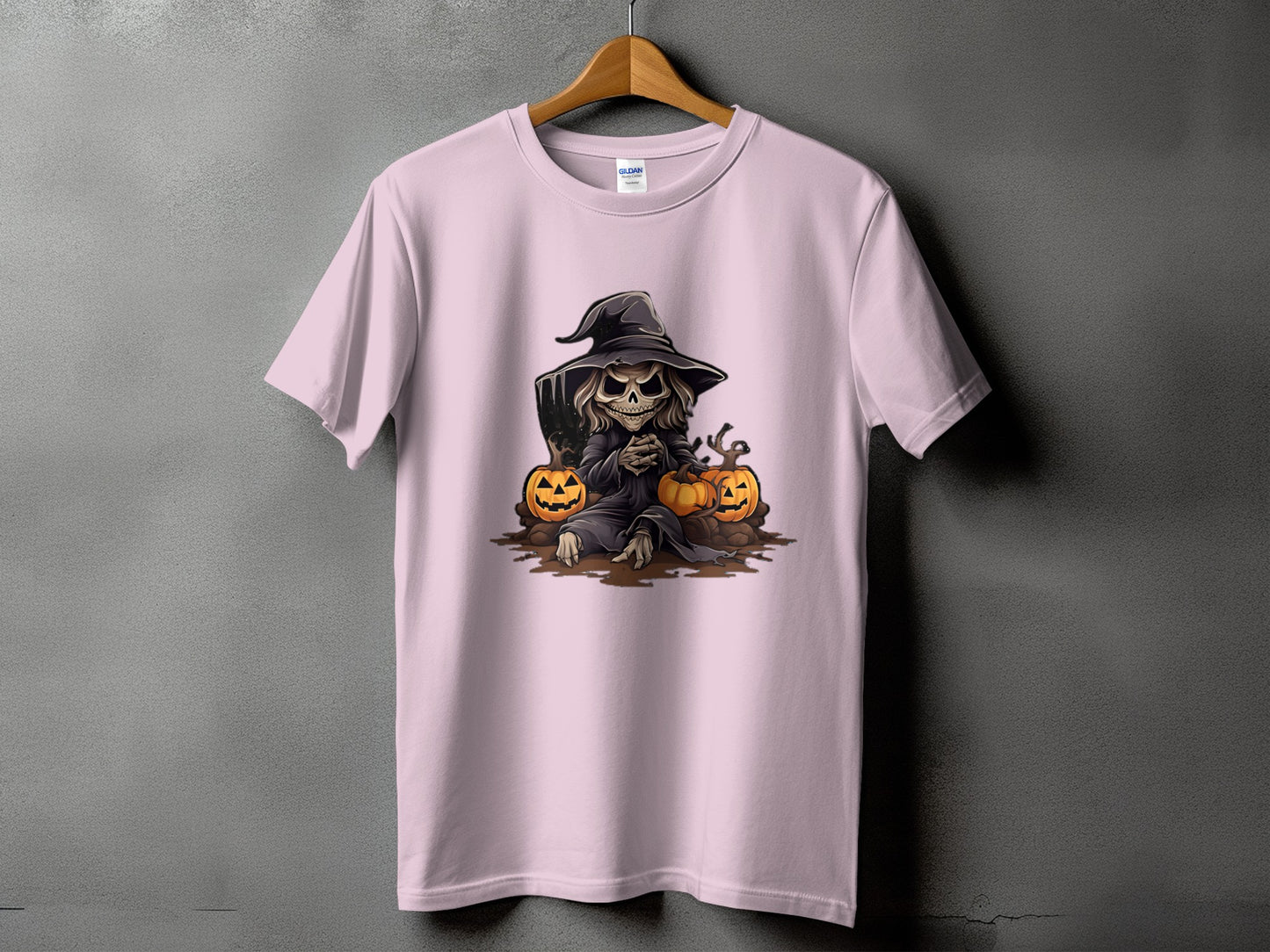 Grim reaper skeleton with witch hat and pumpkins graphic on a pink t-shirt.