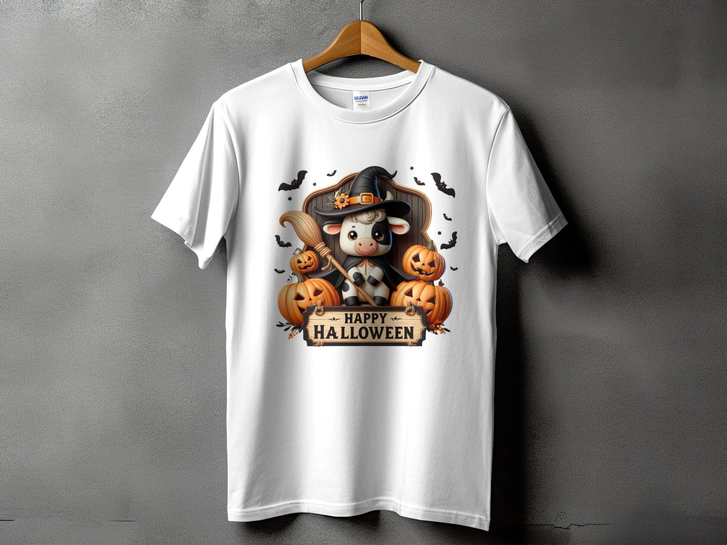 White t-shirt with a Halloween cow design featuring pumpkins and bats.
