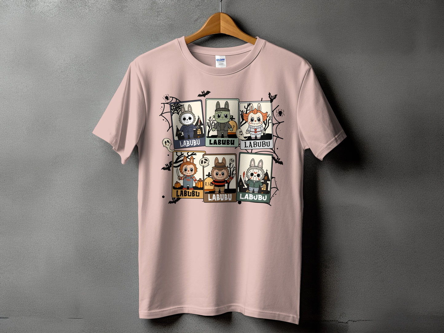 Pink t-shirt with six cartoon horror characters on a grey background.