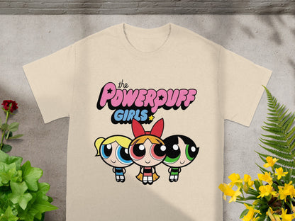 The Powerpuff Girls logo with Blossom, Bubbles, and Buttercup on a cream t-shirt.