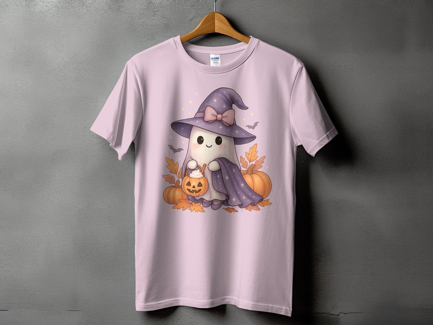 Pink t-shirt with a cute ghost in a witch hat holding a pumpkin basket.