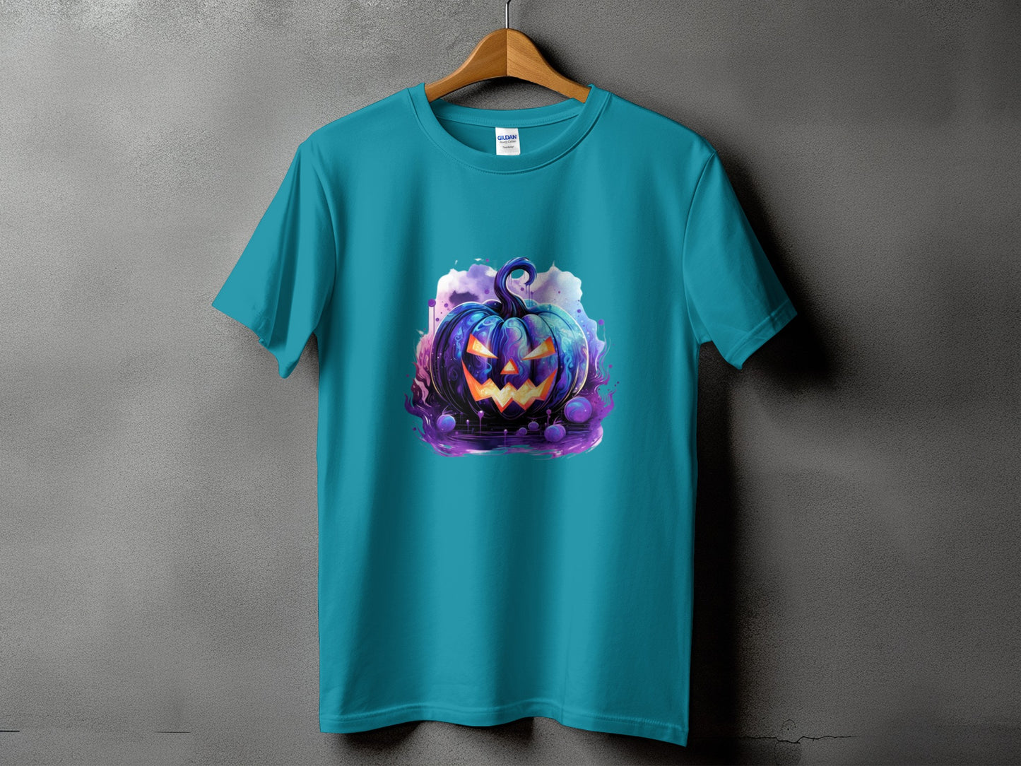 Teal t-shirt with a vibrant, spooky Halloween pumpkin graphic.