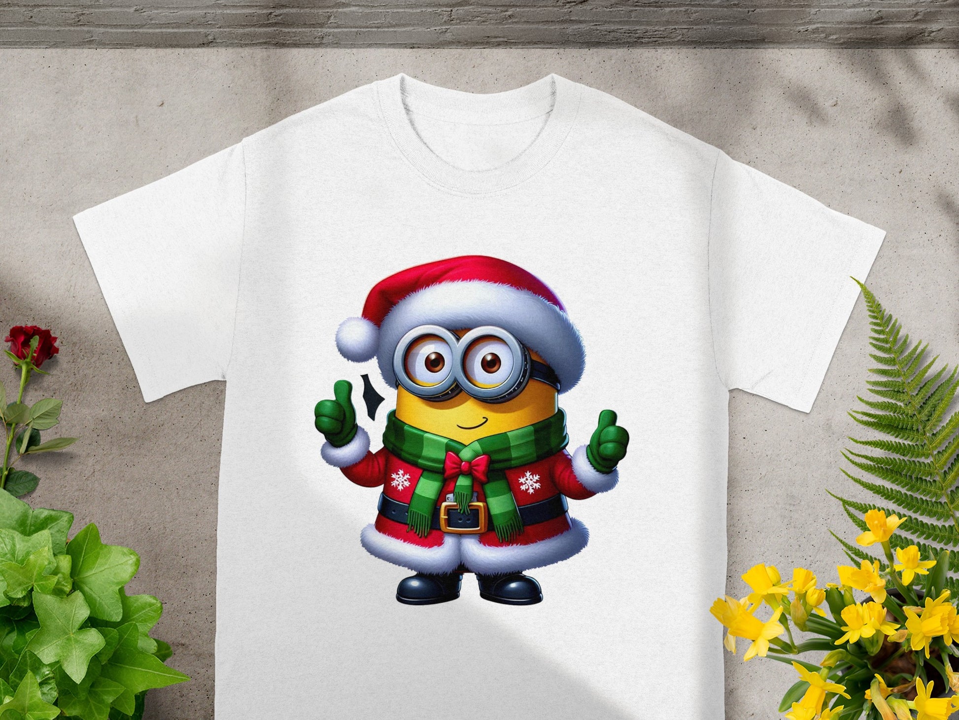 Minion in Christmas attire with Santa hat and green scarf giving thumbs up.