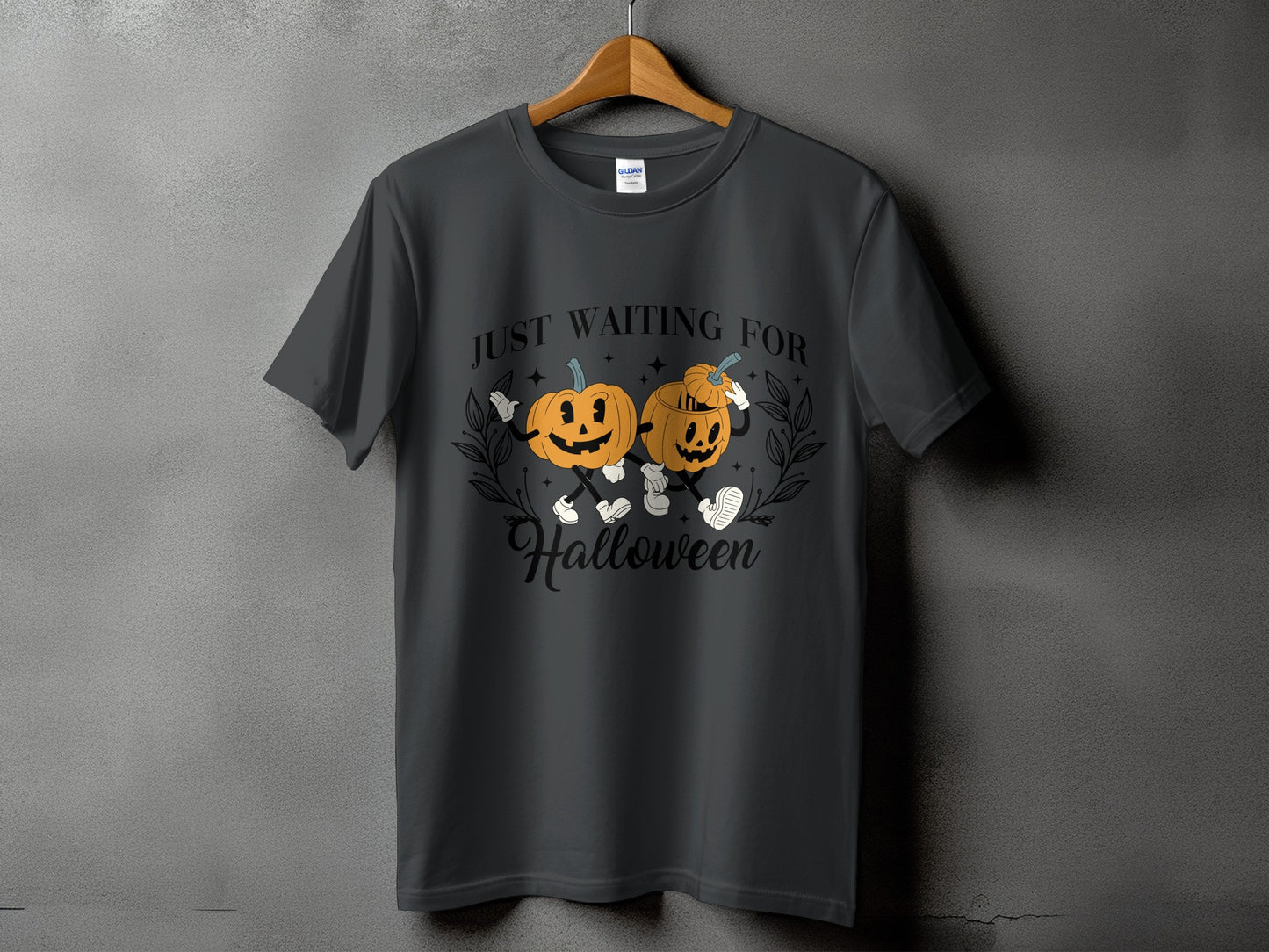 Dark gray t-shirt with two cartoon pumpkins and text "JUST WAITING FOR Halloween".