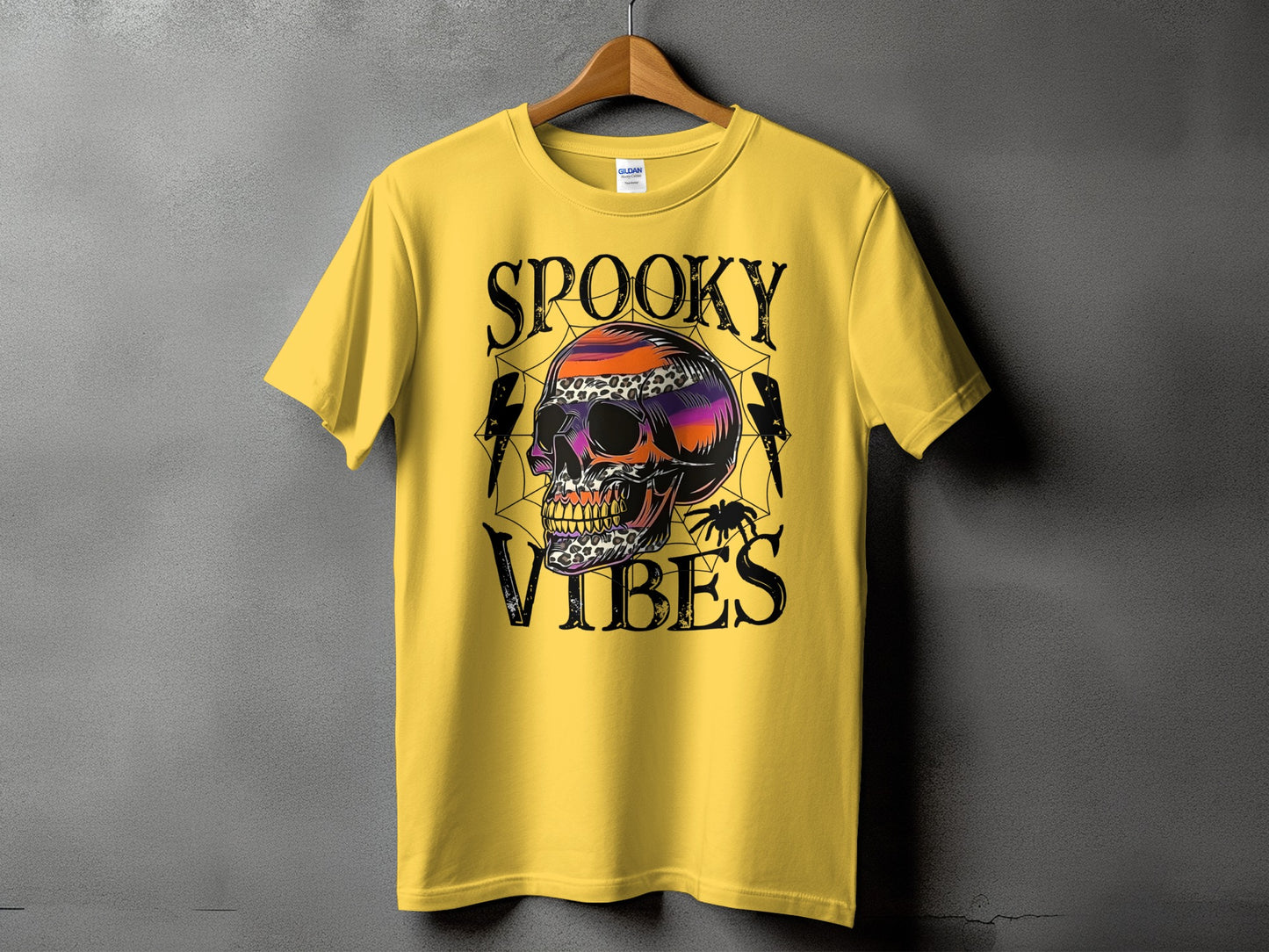 Yellow t-shirt with "Spooky Vibes" text and a colorful skull graphic.