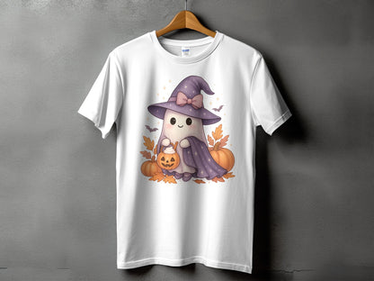 White t-shirt with cartoon ghost in witch hat holding pumpkin, surrounded by pumpkins and leaves.