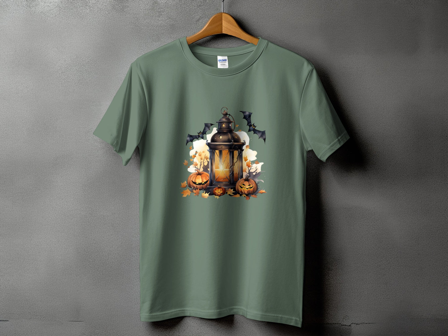 Green t-shirt with a Halloween lantern, pumpkins, bats, and autumn leaves graphic.