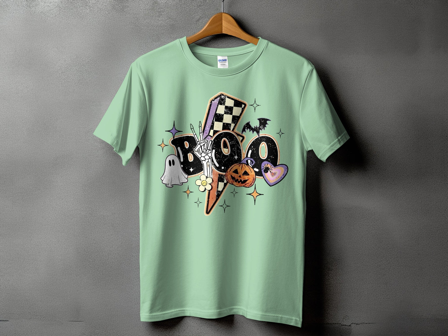Mint t-shirt with distressed "BOO" graphic featuring Halloween icons.