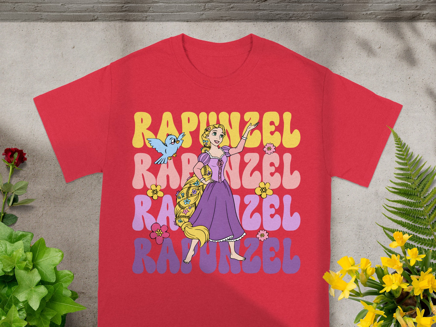 Red t-shirt with Rapunzel graphic and Pascal the chameleon.
