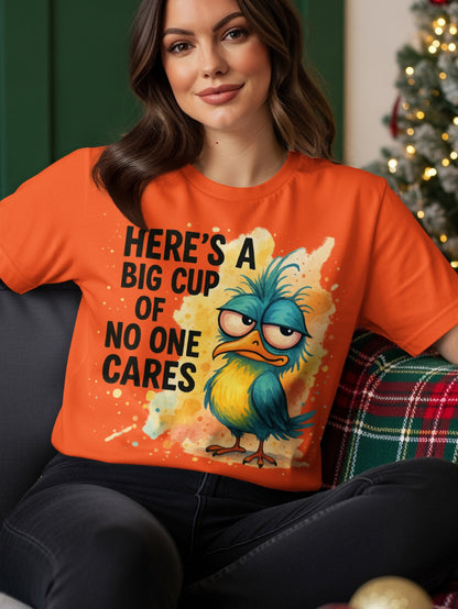 Orange t-shirt with a cartoon bird saying "Here's a big cup of no one cares".