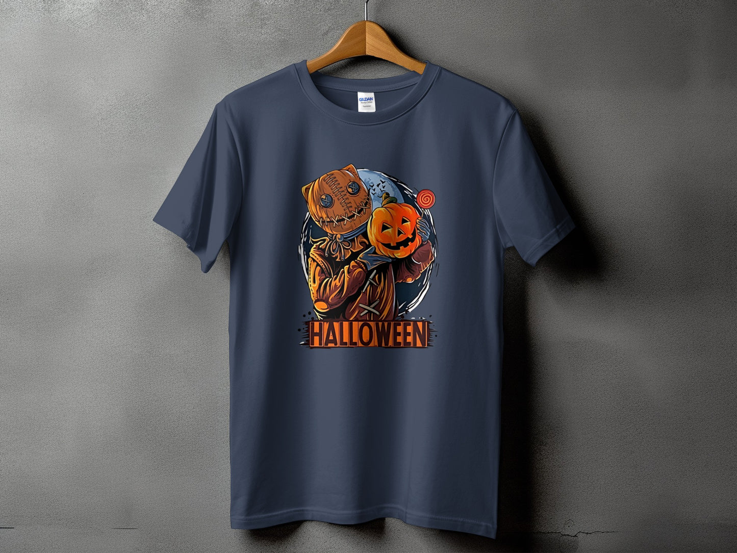 Dark t-shirt with stitched burlap scarecrow holding a pumpkin and lollipop, text reads Halloween.