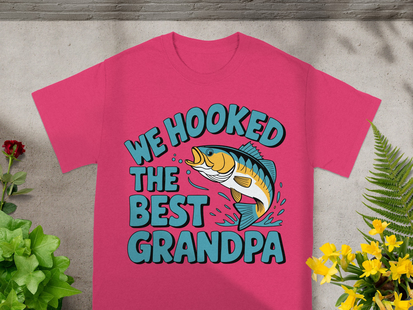 Pink t-shirt with "WE HOOKED THE BEST GRANDPA" text and a leaping fish.