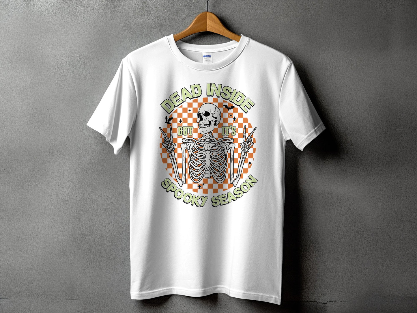 White t-shirt with skeleton graphic and text "Dead Inside But It's Spooky Season".