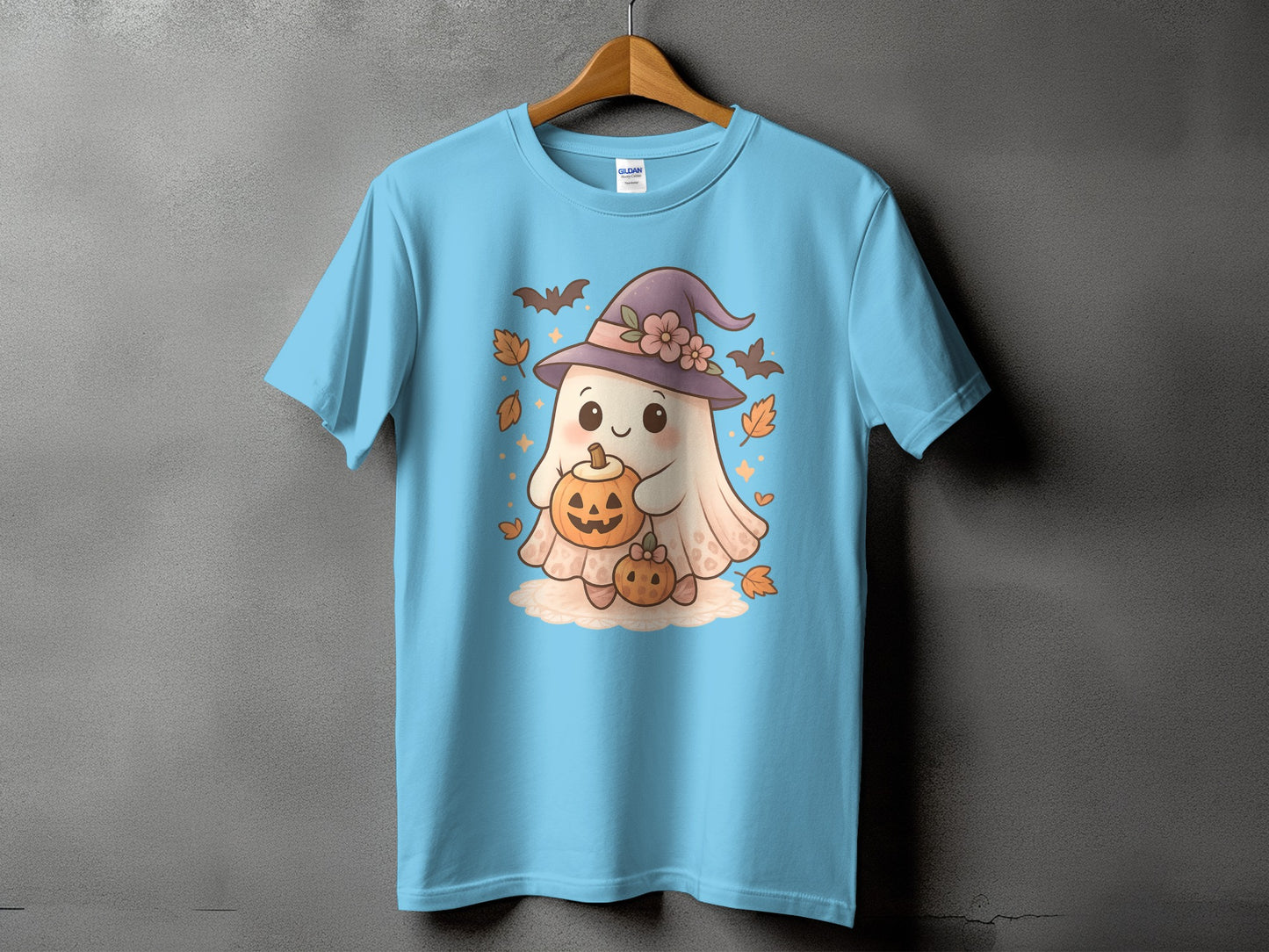 Light blue t-shirt with a cute ghost wearing a witch hat holding pumpkins.