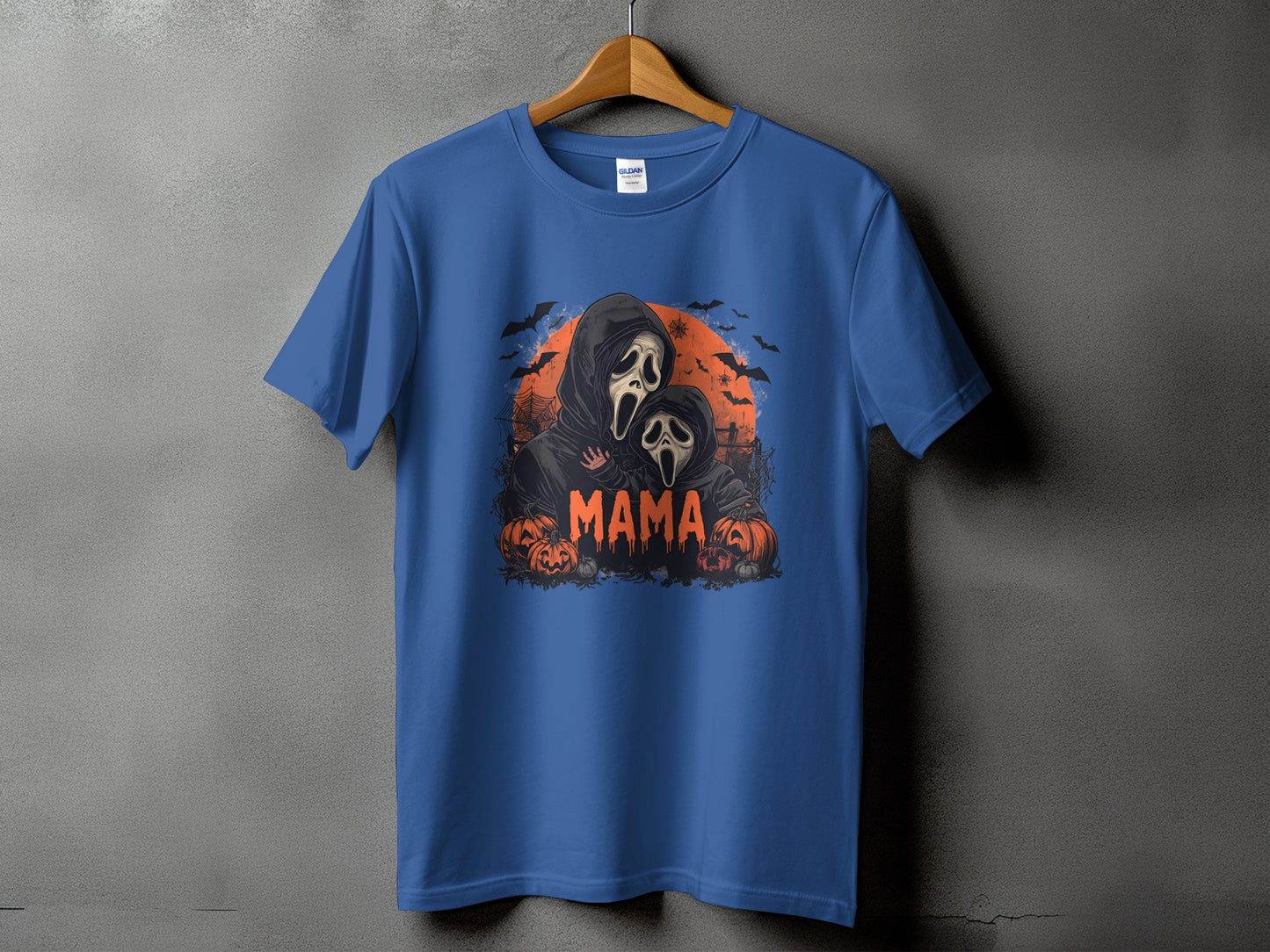 Blue t-shirt with "Mama" in orange text, ghost-like figures, pumpkins, and bats.