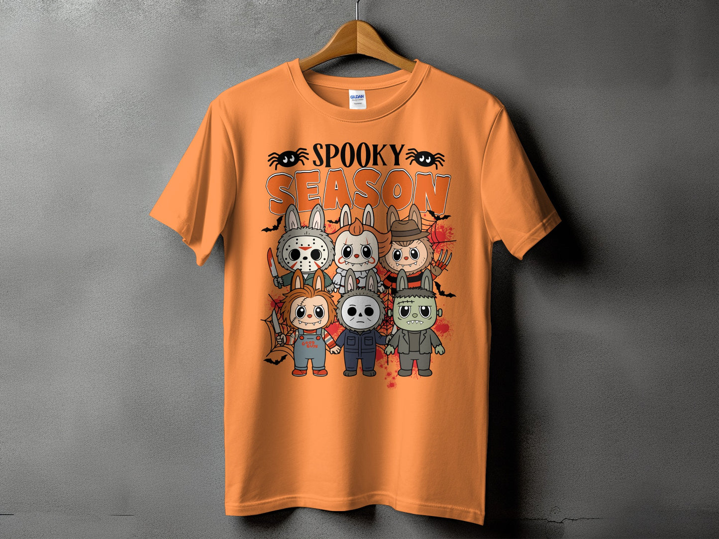 Orange t-shirt with "Spooky Season" text and cartoon horror characters.