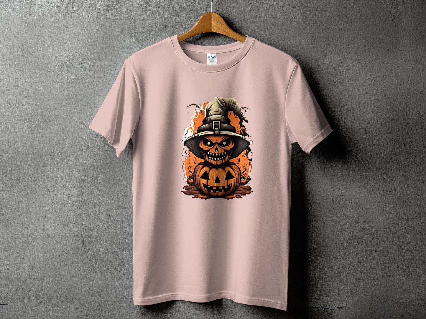 Pink t-shirt with a spooky jack-o'-lantern wearing a witch hat graphic.