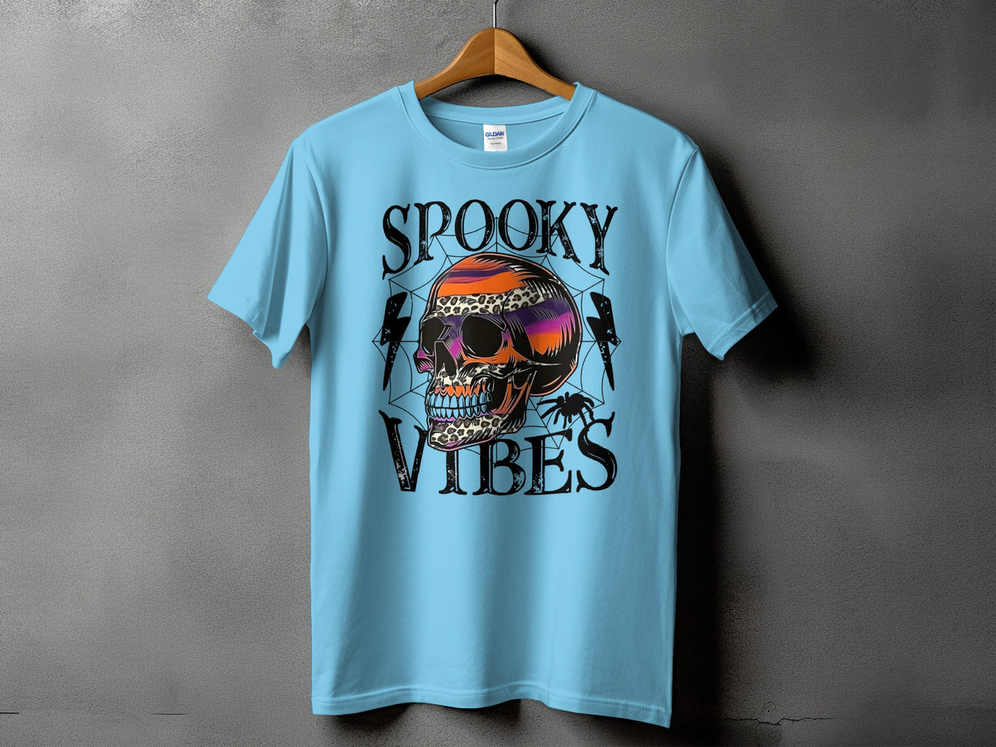 Light blue t-shirt with "Spooky Vibes" text and a colorful skull graphic.